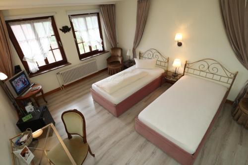 an overhead view of a bedroom with two beds at Schwarzwaldhotel Stollen in Gutach im Breisgau