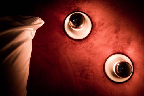 a close up of two buttons on a red wall at Fitz Roy Urban Hotel, Bar and Garden in Maastricht