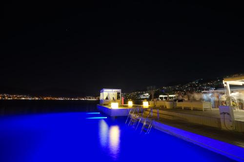 ギュンドガンにあるBilkent Casa Costa Boutique Hotelの夜間の水中の青い照明付きのプール