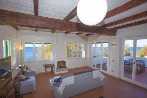 a living room with a couch and a table at Casa Bianca - Goelba in Pomonte