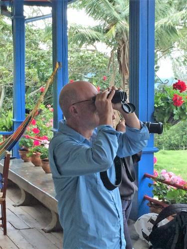 a man taking a picture of a window with a camera at Reserva Guadalajara - Cocora Valley in Salento