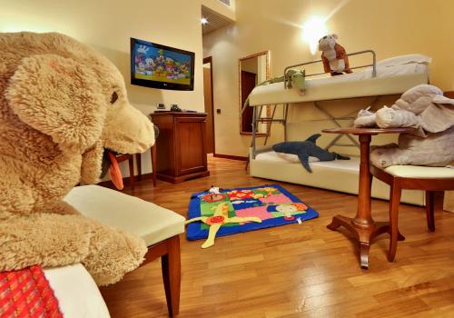 a stuffed elephant sitting in a room with a play area at Best Western Hotel Metropoli in Genova
