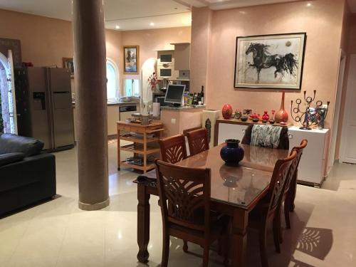 a kitchen and living room with a table and chairs at Europa mirlef t aventur Guest House in Mirleft