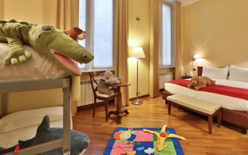 a bedroom with two beds and a dinosaur toy at Best Western Hotel Metropoli in Genova