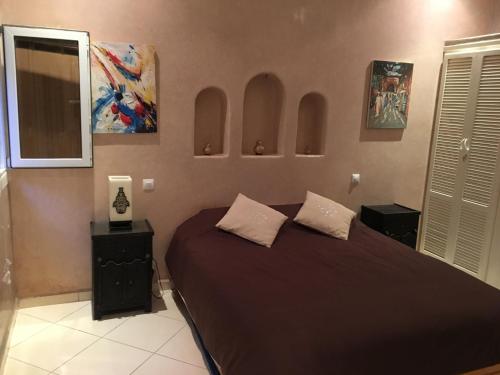 a bedroom with a bed with two pillows on it at Europa mirlef t aventur Guest House in Mirleft