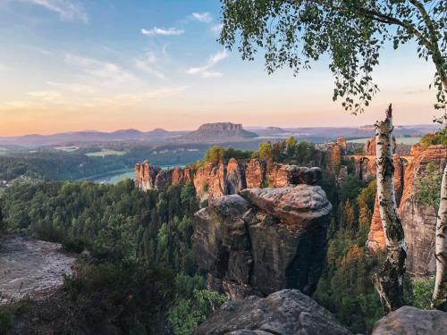 a view of the blue mountains at sunset at Manufaktur Boutique Hotel in Stadt Wehlen