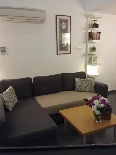 a living room with a couch and a coffee table at Agnanti Apartments in Argaka