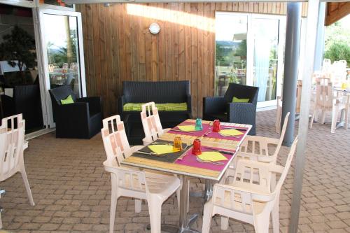 a table and chairs in a room with a table and chairsktop at Les Portes d'Apcher in Saint-Chély-dʼApcher