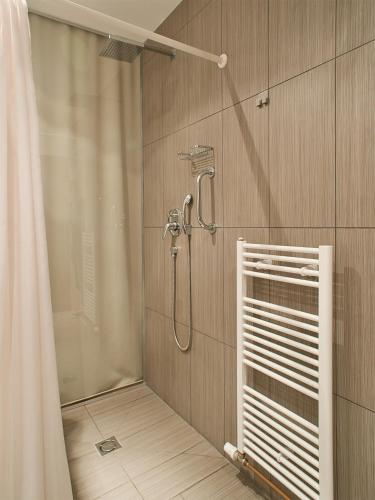 a bathroom with a shower with a shower curtain at Hotel PurPur in Prague