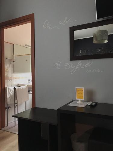 a bathroom with a mirror and a black counter at Hotel Opera' in Moscufo