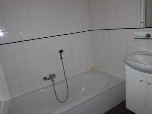 a bathroom with a bath tub and a sink at Ard'envie Bed&Breakfast in Cetturu