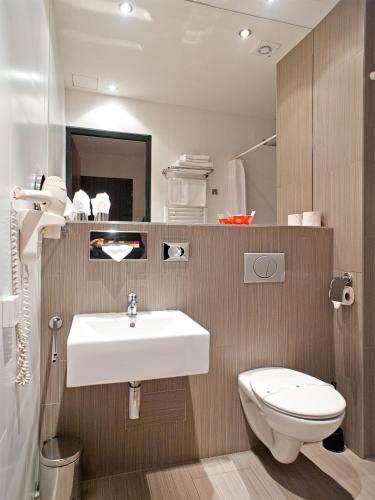a bathroom with a sink and a toilet at Hotel PurPur in Prague