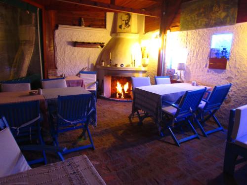 a restaurant with tables and chairs and a fireplace at Amazon Antique in Selcuk