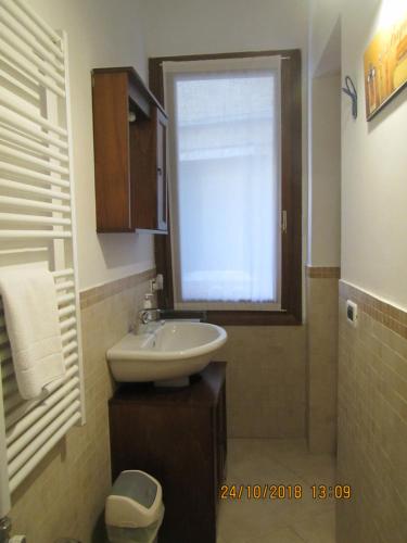 a bathroom with a sink and a window at Bell Tower House in Venice
