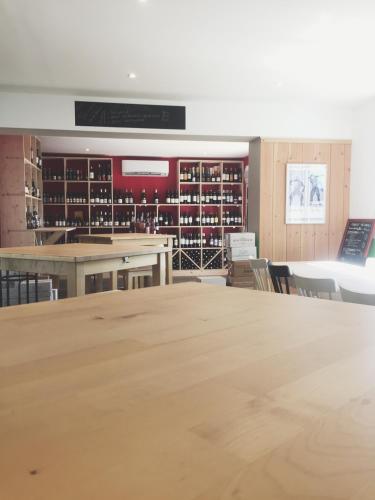 an empty room with a large table and chairs at Hôtel Restaurant AKENA La Brède in La Brede