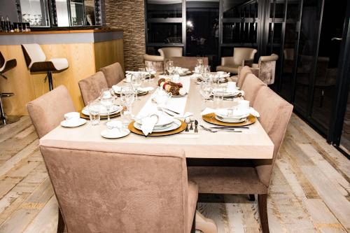 a table in a restaurant with a table set with glasses at Mmakgabo Boutique Lodge in Bela-Bela
