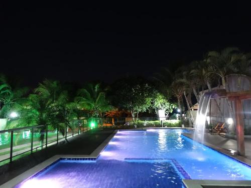 a pool at night with a water slide at Pousada Voo das Garças in Bonito
