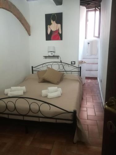 a bedroom with a bed in a white room at Appartamento via del Grillo 8 in Perugia