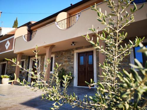 a house with two balconies on top of it at Apartments Gea in Lucija