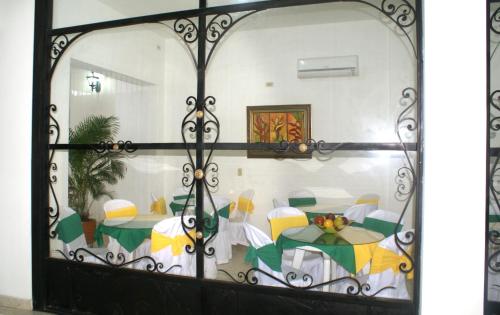 a glass door with a table with umbrellas at Hotel Casa Pablo in Neiva