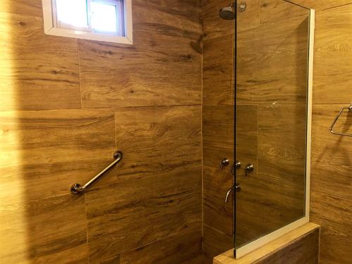 a bathroom with a shower with a glass door at Hotel Villa Santa Maiani in Mar del Plata