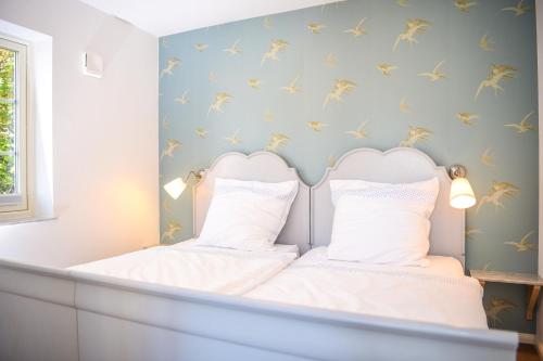a room with a bed with two white pillows at Haus Madita in Breitnau