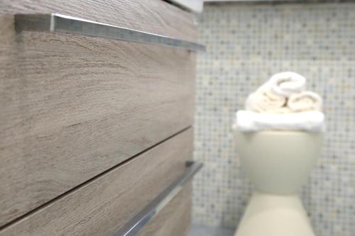 a white toilet in a bathroom with a wall at Primo a destra in Campobasso