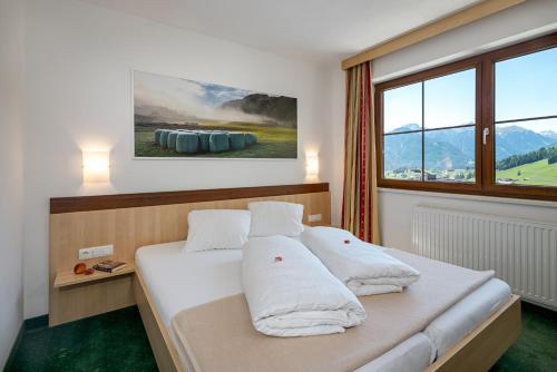 Postel nebo postele na pokoji v ubytování Apart-Hotel Aurora Fiss