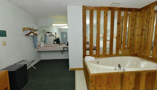 a bathroom with a bath tub in a room at Americas Best Value Inn Saint Ignace in Saint Ignace