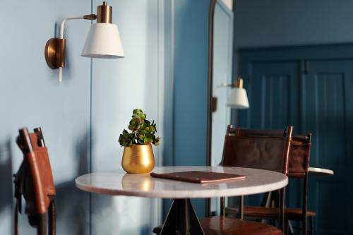 a table topped with a plant and a lamp at The Chicago Hotel Collection Wrigleyville in Chicago