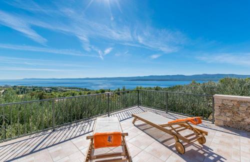 a patio with a table and two chairs on a balcony at House Petric in Bol