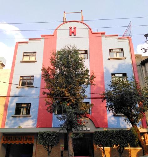 a building with a painting on the side of it at Hotel H - Fabiola Adults Only in Mexico City