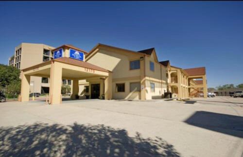 a large building with a sign on top of it at Americas Best Value Inn and Suites Houston/Northwest Brookhollow in Houston