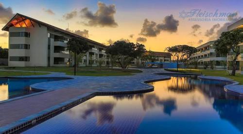 a large swimming pool in front of a building at Carneiros Beach Resort in Tamandaré