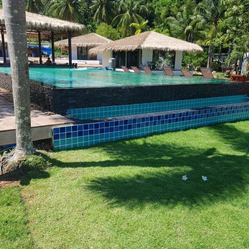 a swimming pool with chairs next to a resort at Sunrise Beach Resort in Ko Chang