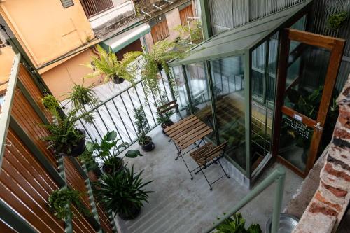an overhead view of a balcony with a bench and plants at Live Local Cafe & Hotel - 420 Friendly in Bangkok