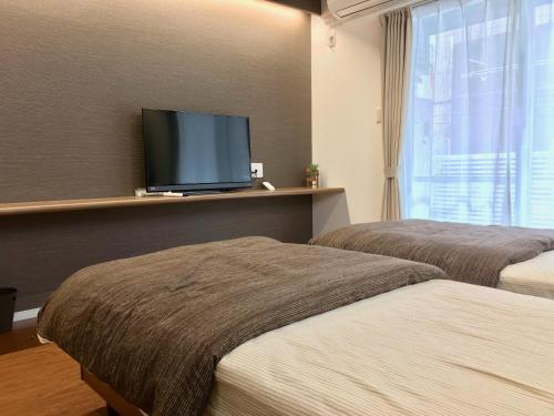 Postel nebo postele na pokoji v ubytování A-Style Futenma