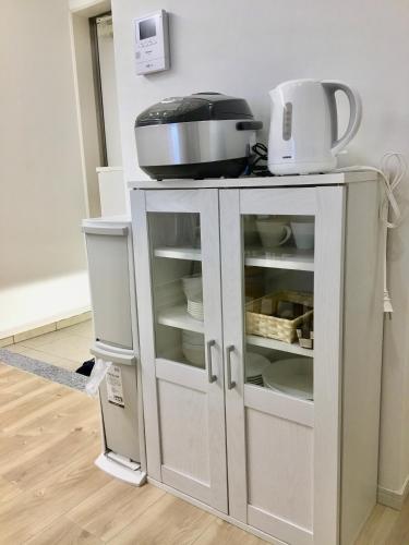 a white cabinet with a mixer on top of it at A-Style Futenma in Ginowan