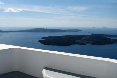 an island in the middle of a large body of water at Irida - Santorini in Imerovigli