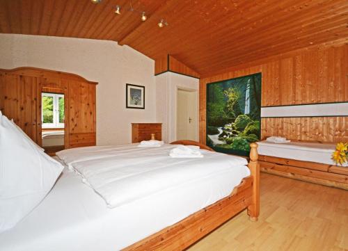 a bedroom with a large white bed and a window at Ferienhaus Zirchow 2 in Zirchow