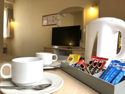 a table with a tray with a cup and a coffee maker at The Clarendon Motel Katoomba in Katoomba