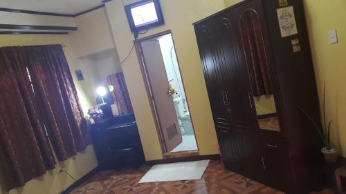 a hallway with a door and a mirror in a room at Carribean Transient House in Lucap