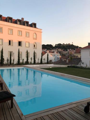 a large swimming pool in front of a building at Mouraria Best Apto in Lisbon
