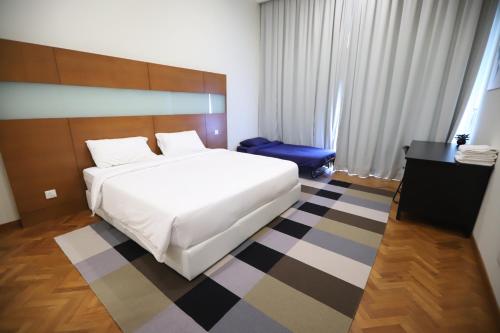a bedroom with a white bed and a checkered floor at The Straits Quay Marina by Messina Clive in George Town