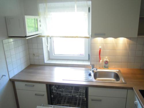 a small kitchen with a sink and a window at Ferienhaus Höchhäusl in Werfenweng