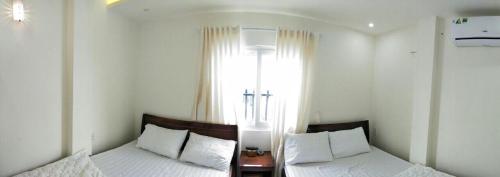 Ένα ή περισσότερα κρεβάτια σε δωμάτιο στο Thanh Sang Guesthouse