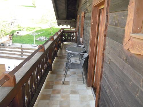 a balcony with two chairs and a table on it at Ferienhaus Höchhäusl in Werfenweng