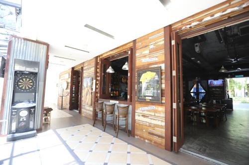a bar with wooden walls and stools in a room at The Straits Quay Marina by Messina Clive in George Town