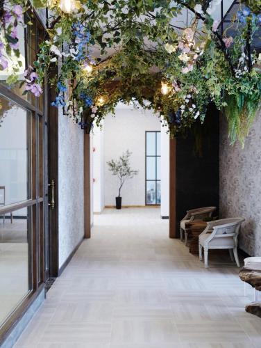 a hallway with flowers hanging from a ceiling at VST Residence -SHA PLUS Certified in Ban Khlong Bang Ping