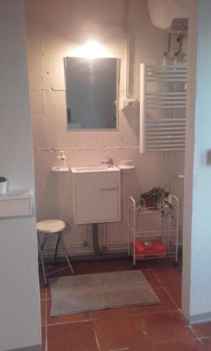 a bathroom with a sink and a tv on the wall at Podere Badia Valdrago Agriturismo Mugello Circuit in Scarperia